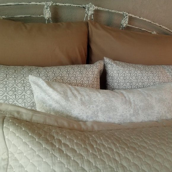Arrangement of vibrant pillowcases in shades in creams and tans.